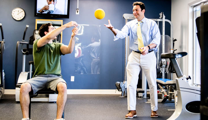 Physical therapist helping patient with lower back pain in Edgewater NJ clinic