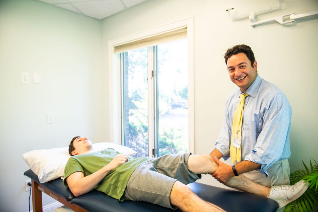 Physical therapist helping patient with knee replacement rehabilitation