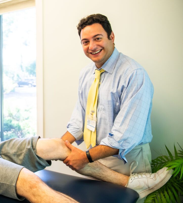 Physical therapist helping patient with knee replacement rehabilitation
